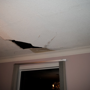 Structural roof distortion and sagging timber lines on a residential roof structure